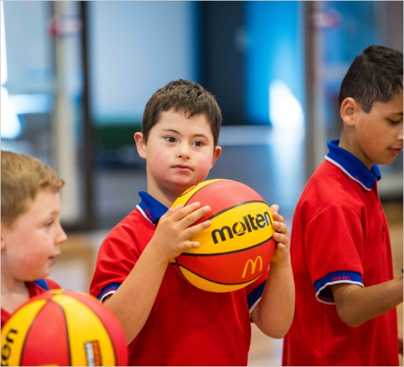 Variety Sports Day With young boy holding ball to include all children.